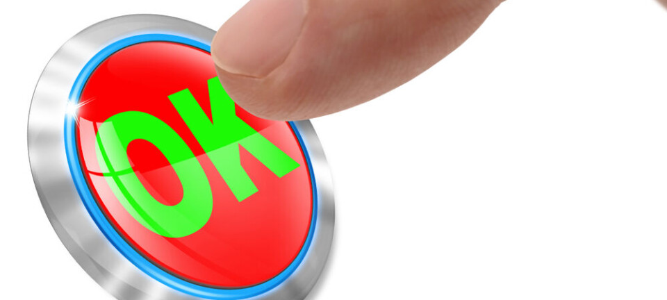 A finger presses a red OK button on a white background.