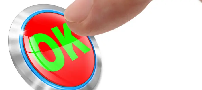 A finger presses a red OK button on a white background.